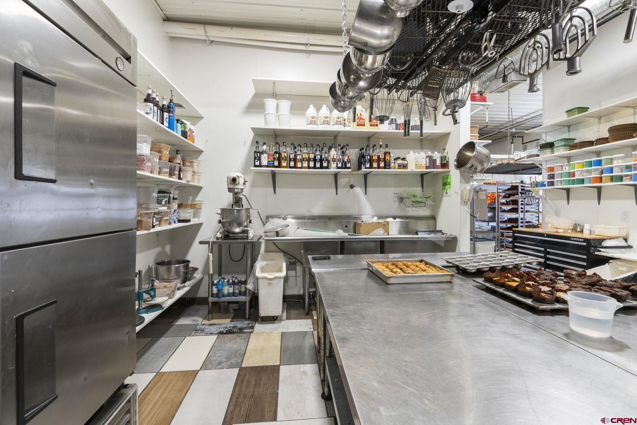 3206 Main Avenue Durango, CO 81301 - Photo 13 of 45 a hallway with lots of clutter and stainless steel appliances