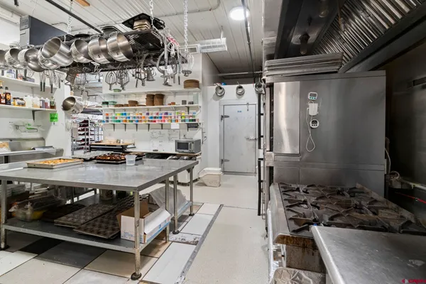 a kitchen with stainless steel appliances granite countertop a stove and a refrigerator