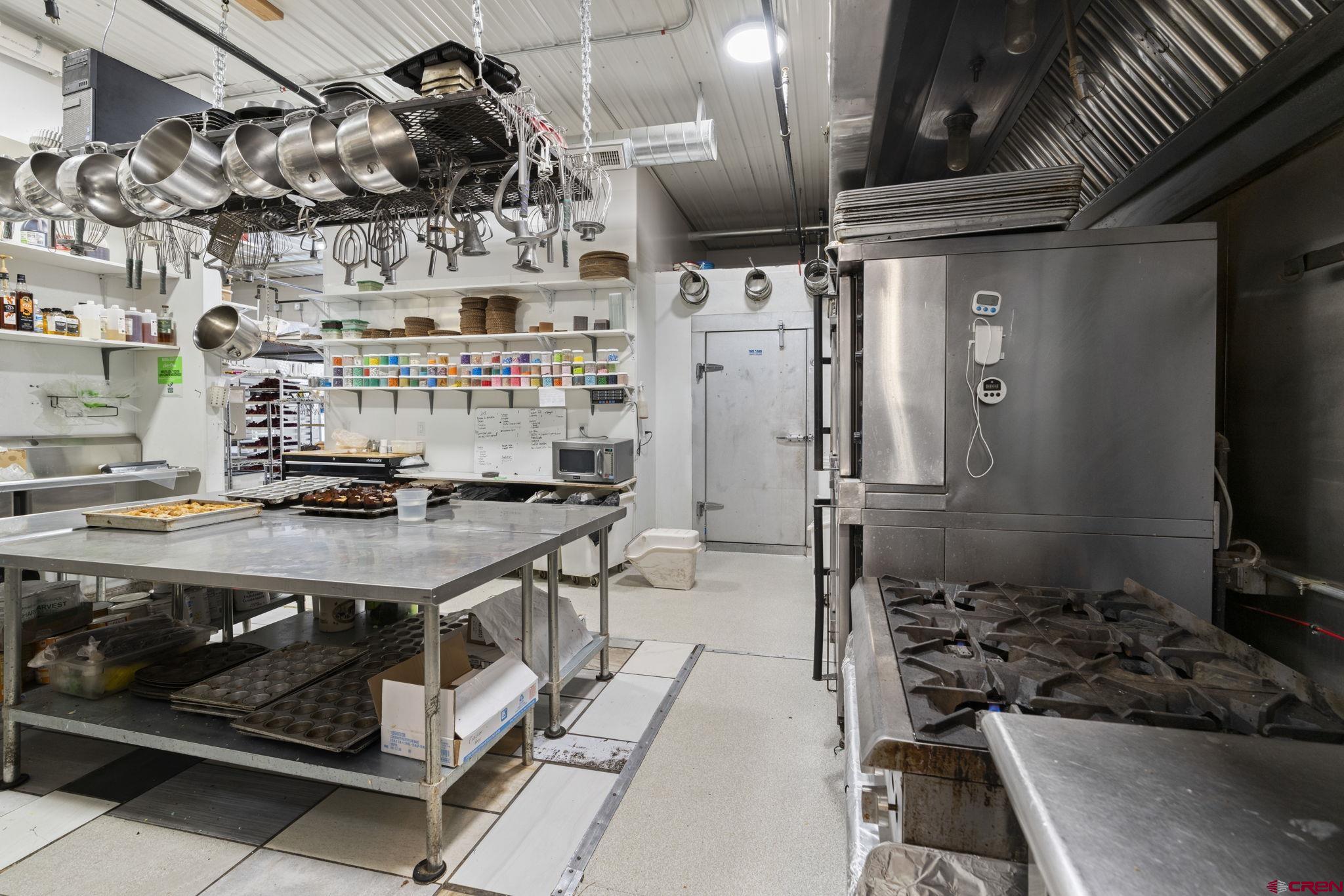3206 Main Avenue Durango, CO 81301 - Photo 14 of 45 a kitchen with stainless steel appliances granite countertop a stove and a refrigerator