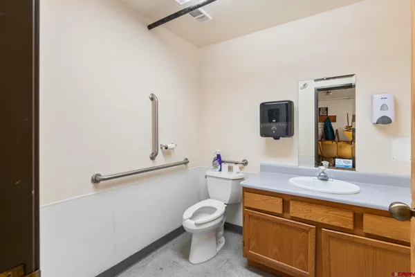 a bathroom with a toilet sink and mirror