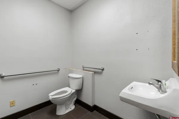 an empty room with a mirror and a ceiling fan