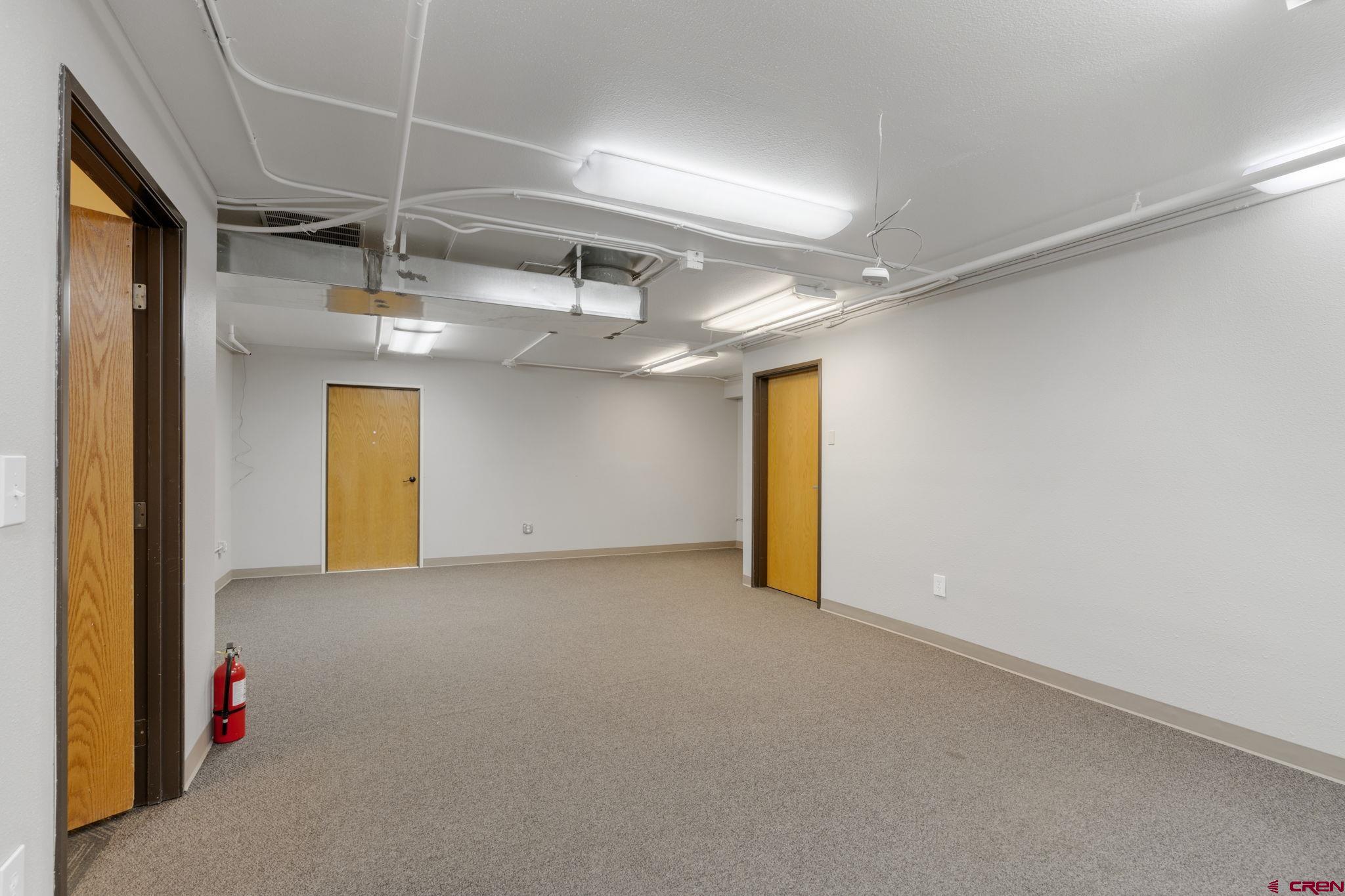 3206 Main Avenue Durango, CO 81301 - Photo 31 of 45 an empty room with a mirror and a ceiling fan