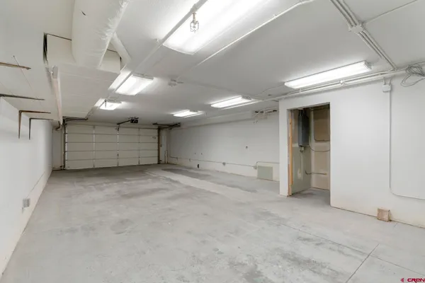 a view of a hallway with wooden floor and closet