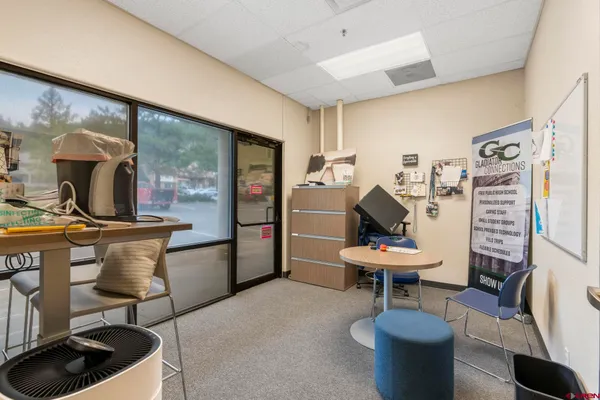 a living room with furniture gym and a large window