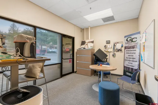 a living room with furniture gym and a large window