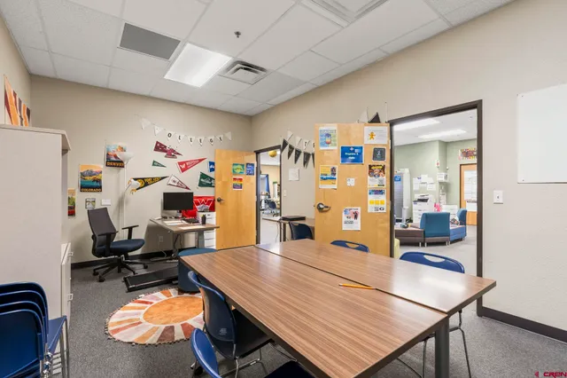 a room with lots of furniture and view of living room