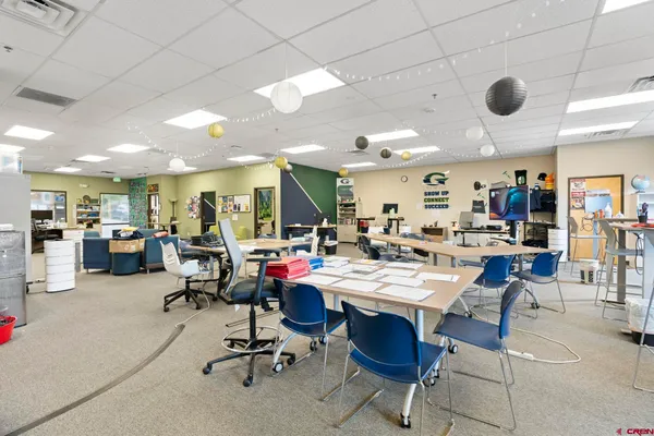 a city view with tall buildings and cars parked in front of it
