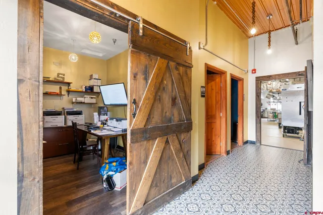 a view of a dining room with a table and chairs