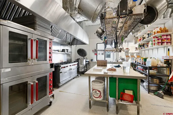 a kitchen with stainless steel appliances granite countertop a stove and a sink