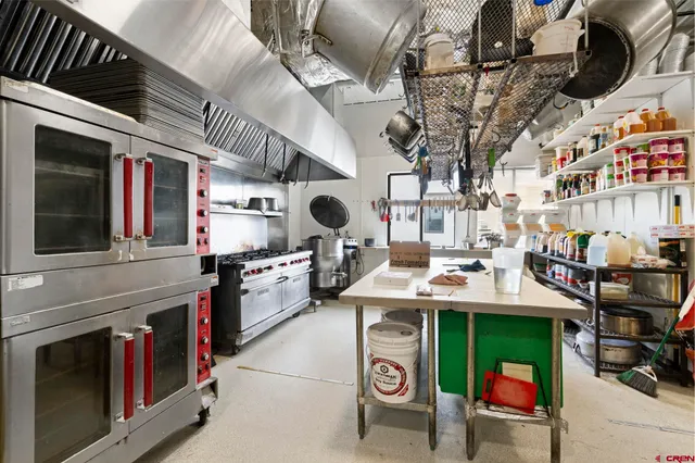 a kitchen with stainless steel appliances granite countertop a stove and a sink