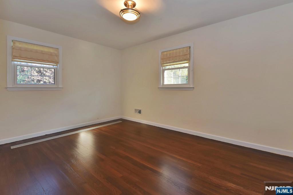 4 Marconi Street Tenafly, NJ 07670 - Photo 4 of 35 a view of an empty room with wooden floor and a window