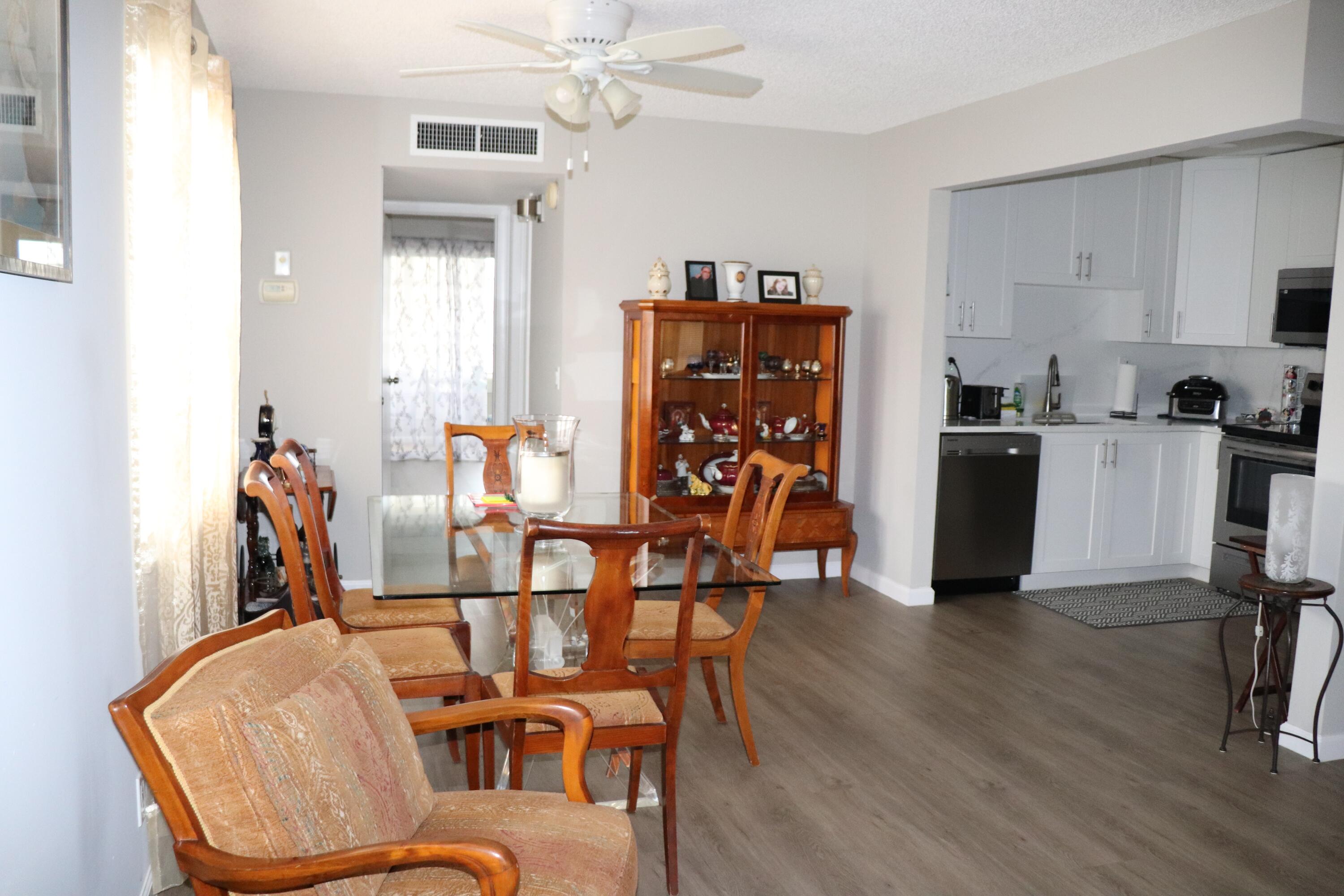 801 Flanders South, Unit Q Delray Beach, FL 33484 - Photo 4 of 15 a dining room with furniture and wooden floor