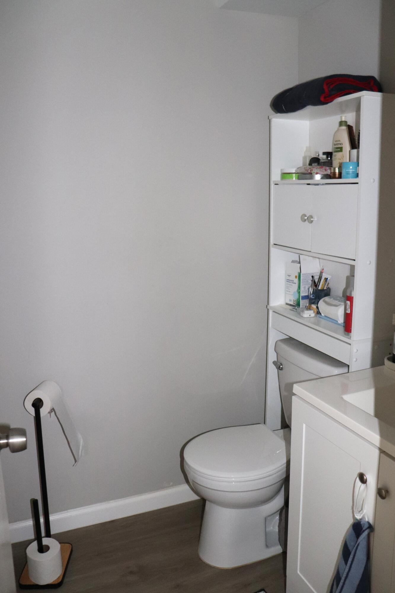 801 Flanders South, Unit Q Delray Beach, FL 33484 - Photo 6 of 15 a bathroom with a toilet and a wooden floor