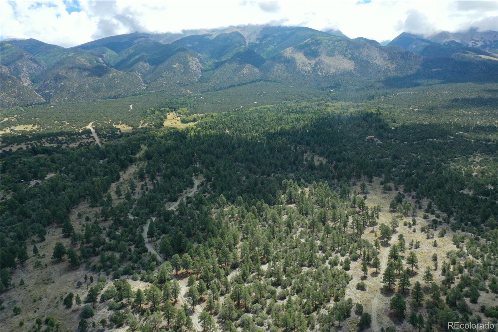 Conejos Place Mosca, CO 81146 - Photo 1 of 23 a view of a lush green hillside and a building