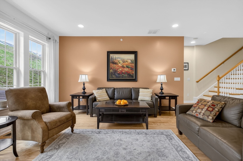 87 Shannon Way, Unit 86 Upton, MA 01568 - Photo 6 of 36 a living room with furniture and a potted plant