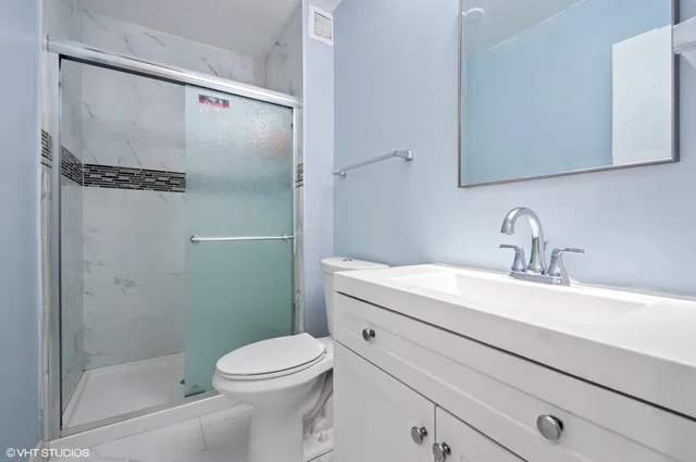 a front view of a house with a yard and potted plants