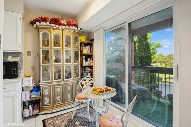 a view of a dining room with furniture and a chandelier