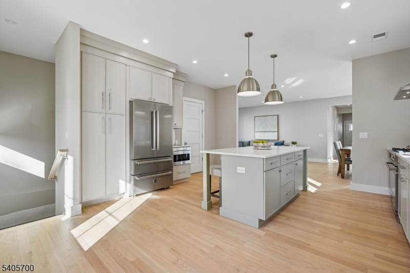 8 Willow Street Millburn, NJ 07041 - Photo 13 of 45 a large kitchen with kitchen island a large counter top a sink stainless steel appliances and cabinets