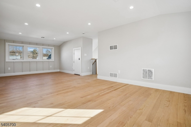 8 Willow Street Millburn, NJ 07041 - Photo 20 of 45 an empty room with wooden floor and windows