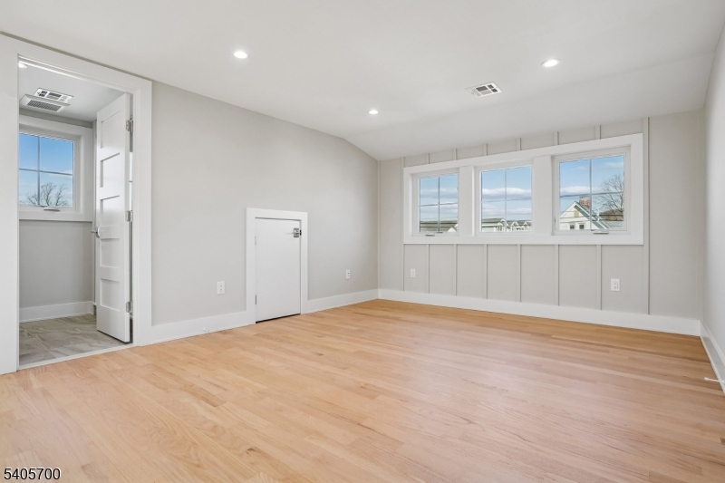 8 Willow Street Millburn, NJ 07041 - Photo 23 of 45 a view of an empty room with wooden floor and a window