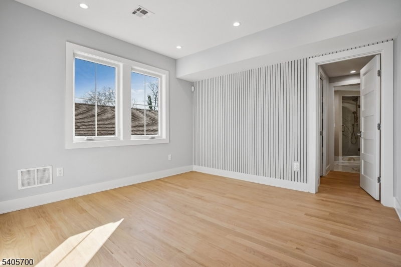 8 Willow Street Millburn, NJ 07041 - Photo 24 of 45 a view of an empty room with wooden floor and a window