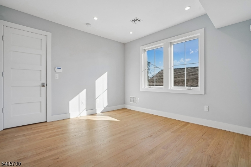 8 Willow Street Millburn, NJ 07041 - Photo 26 of 45 a view of an empty room with wooden floor and a window