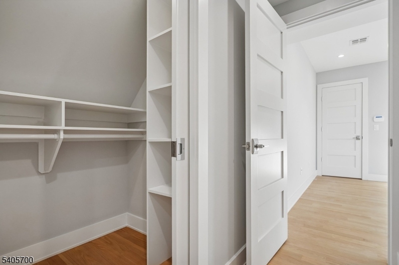 8 Willow Street Millburn, NJ 07041 - Photo 29 of 45 a view of a hallway with wooden floor and closet
