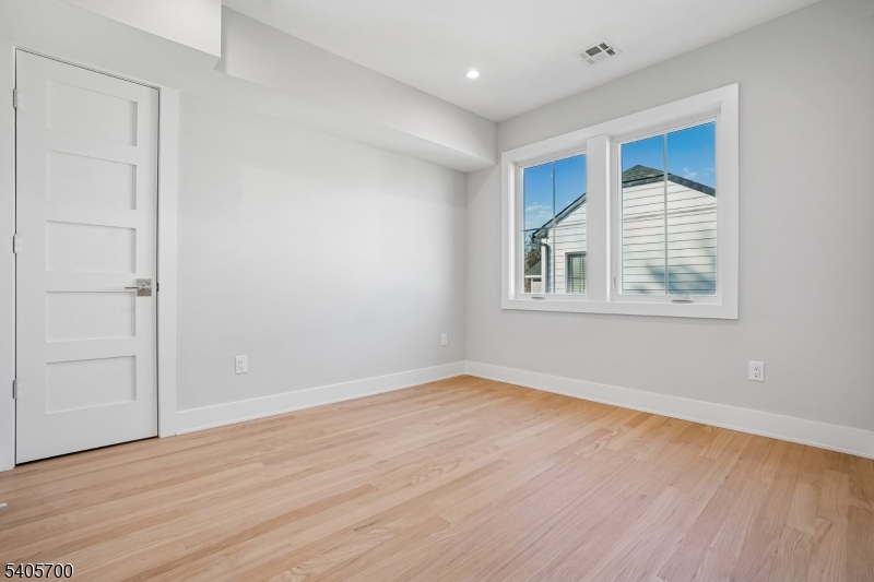 8 Willow Street Millburn, NJ 07041 - Photo 30 of 45 a view of an empty room with wooden floor and a window