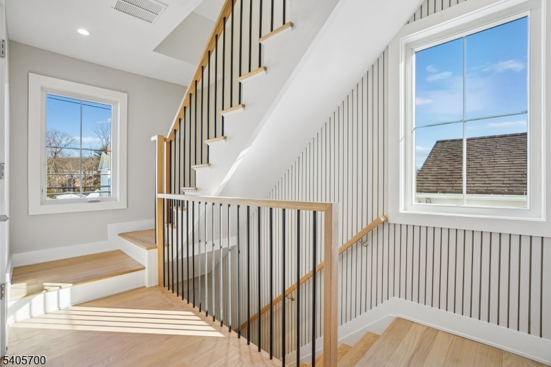 8 Willow Street Millburn, NJ 07041 - Photo 33 of 45 a view of a staircase with wooden floor and windows