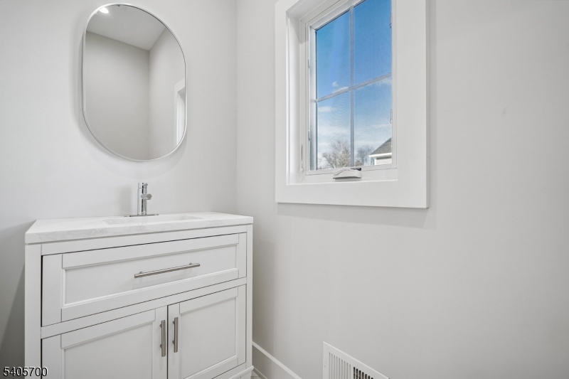 8 Willow Street Millburn, NJ 07041 - Photo 40 of 45 a bathroom with a sink and a mirror