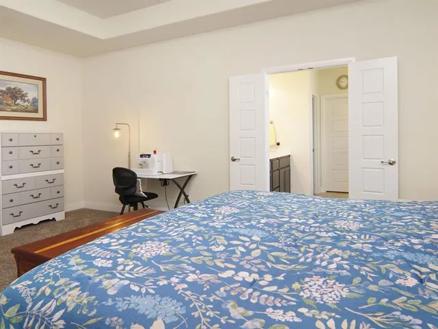 a bedroom with a bed and a large window