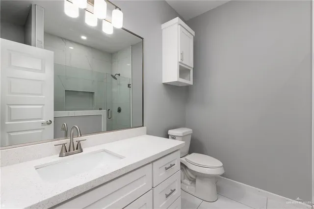 a bathroom with a sink a toilet and mirror