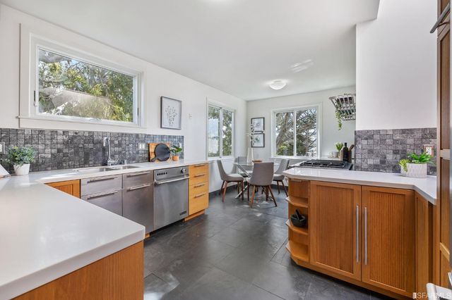 a spacious bedroom with a bed and a lamp on table