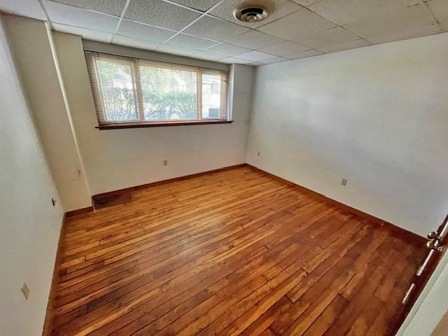 267 Locust Street, Unit 1F Northampton, MA 01062 - Photo 7 of 7 an empty room with wooden floor and windows