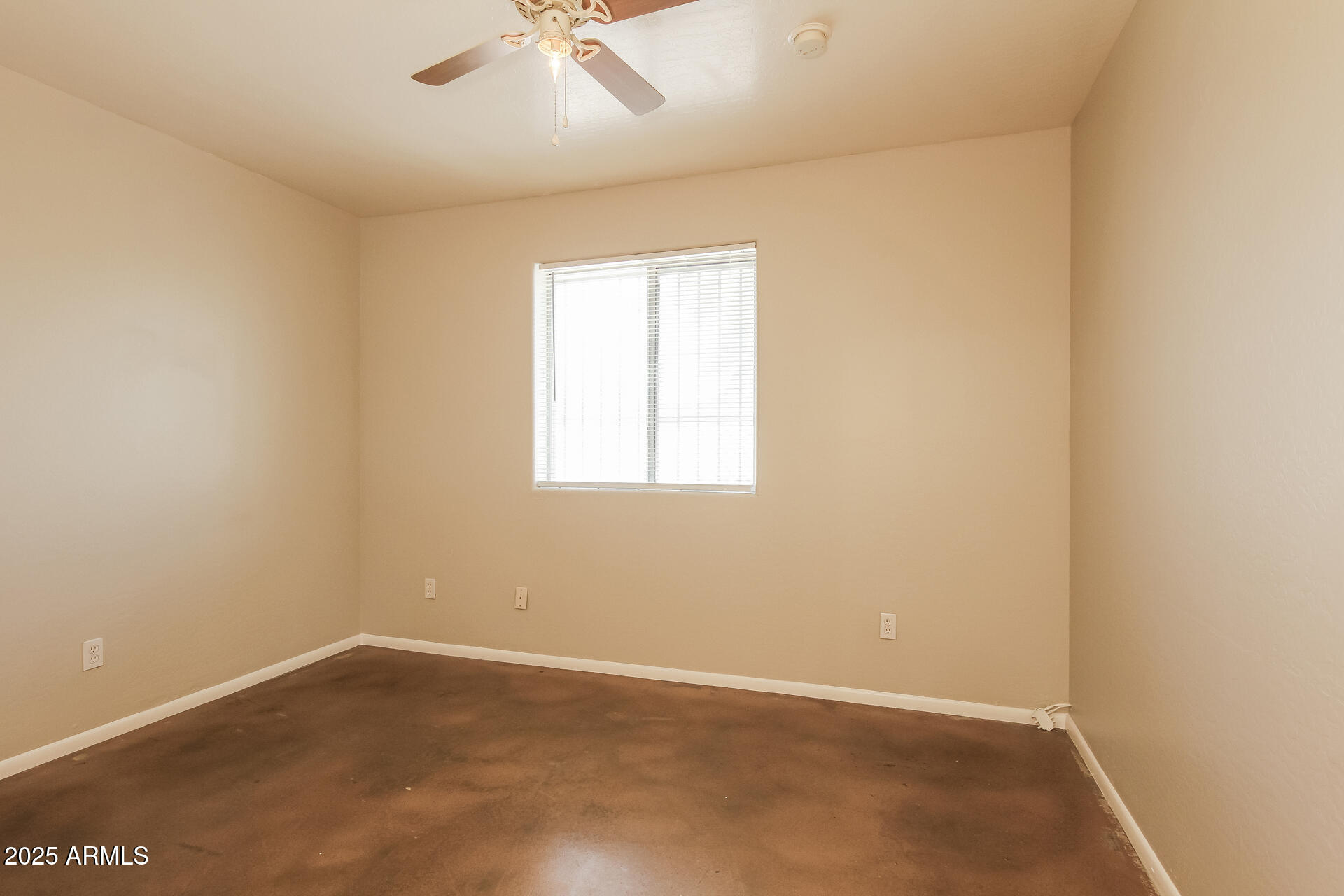 918 South 1st Avenue, Unit 2 Phoenix, AZ 85003 - Photo 13 of 16 an empty room with a window and a ceiling fan