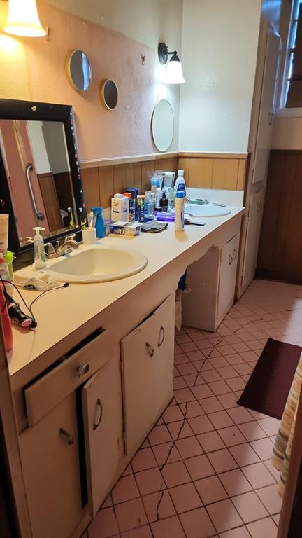5612 Wainwright Drive Fort Worth, TX 76112 - Photo 12 of 17 a bathroom with a sink vanity and mirror