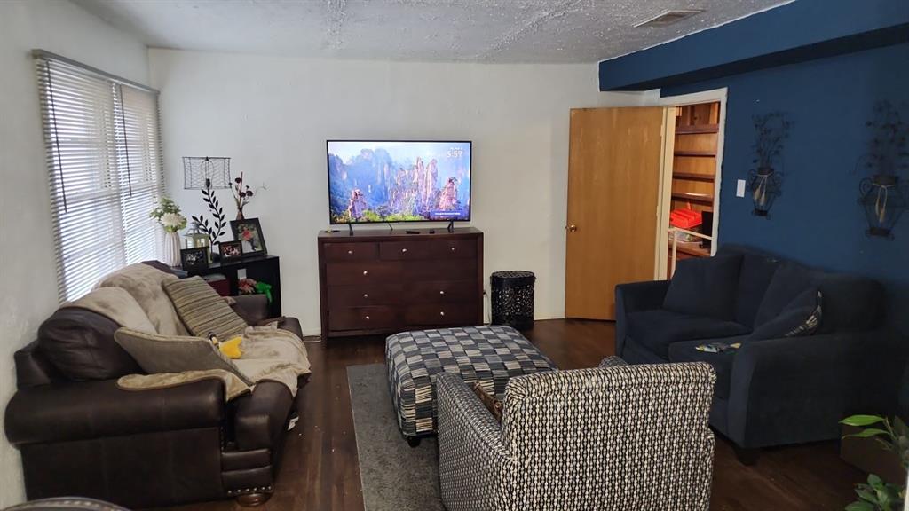5612 Wainwright Drive Fort Worth, TX 76112 - Photo 3 of 17 a living room with furniture a flat screen tv and a dresser