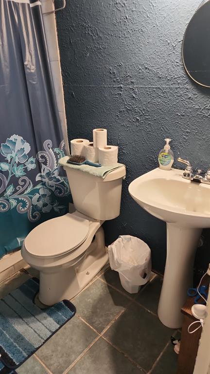 5612 Wainwright Drive Fort Worth, TX 76112 - Photo 6 of 17 a white toilet sitting next to a bathroom sink