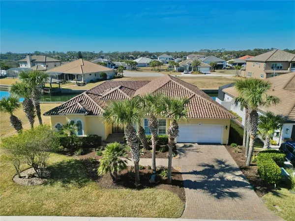 an aerial view of residential houses with outdoor space and seating