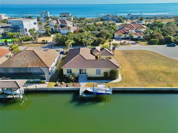 a aerial view of a house with a garden and lake view