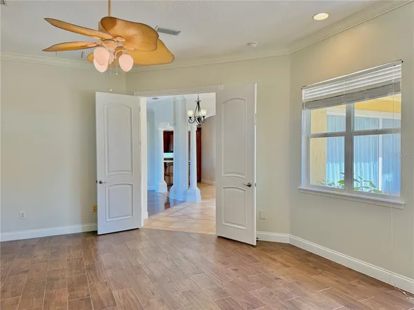 a view of a dining room with furniture a chandelier and wooden floor
