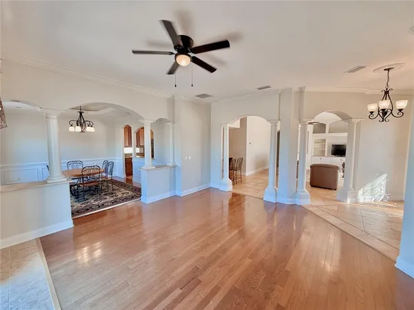 a very nice looking kitchen with granite countertop a stove a sink a window and a dining table