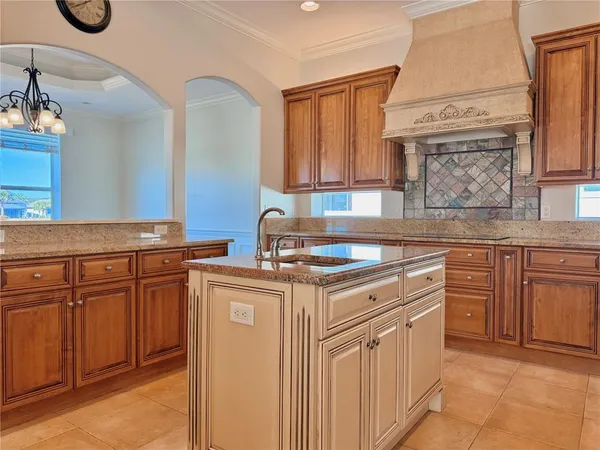 a bathroom with a granite countertop sink a mirror and a bathtub