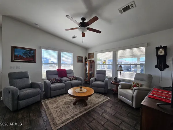 a living room with furniture a rug and a large window