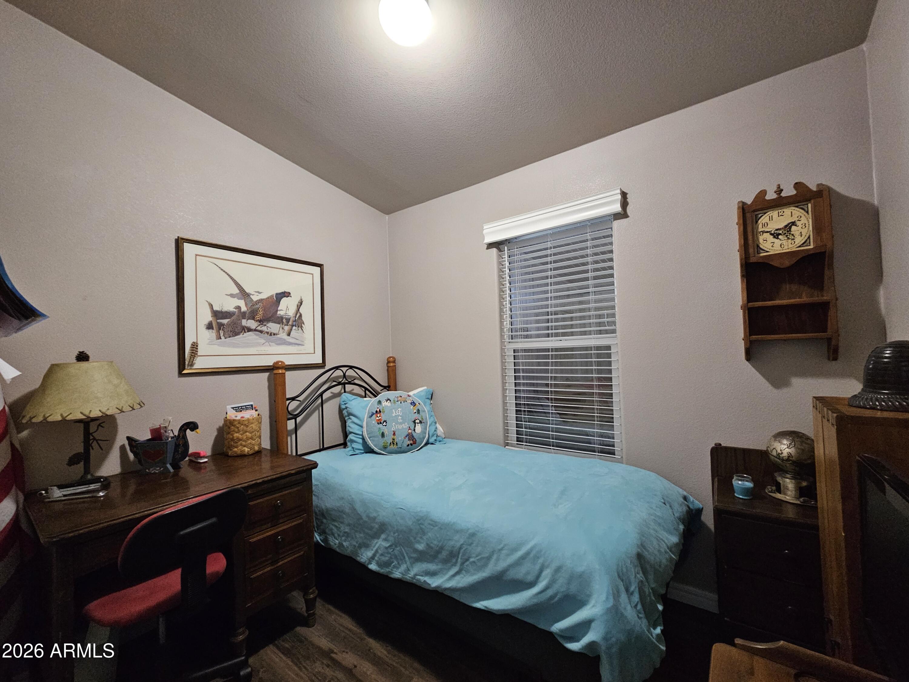 650 North Hawes Road, Unit 3202 Mesa, AZ 85207 - Photo 14 of 35 a bedroom with a bed and a flat screen tv