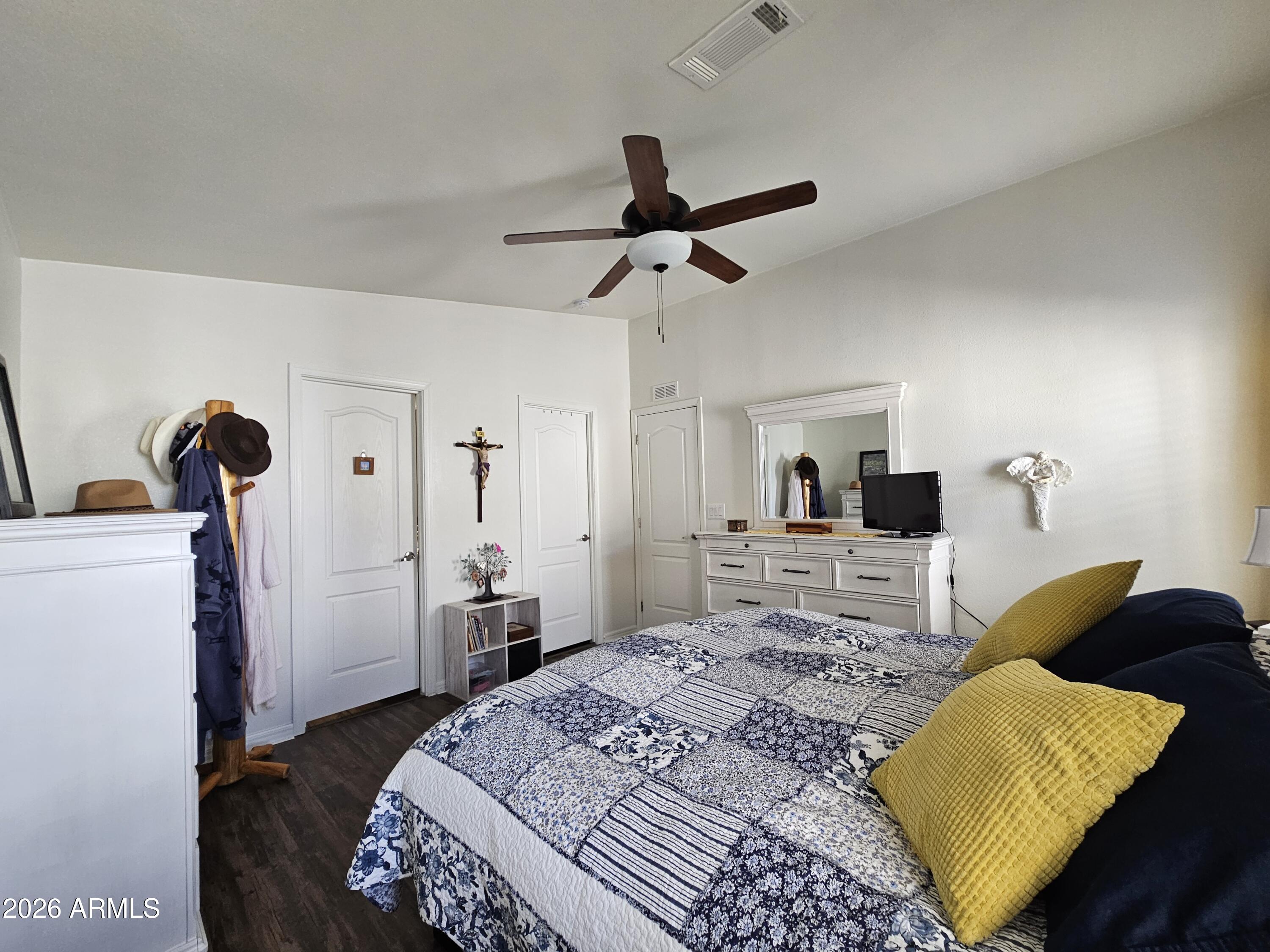 650 North Hawes Road, Unit 3202 Mesa, AZ 85207 - Photo 17 of 35 a bedroom with a bed and wooden floor