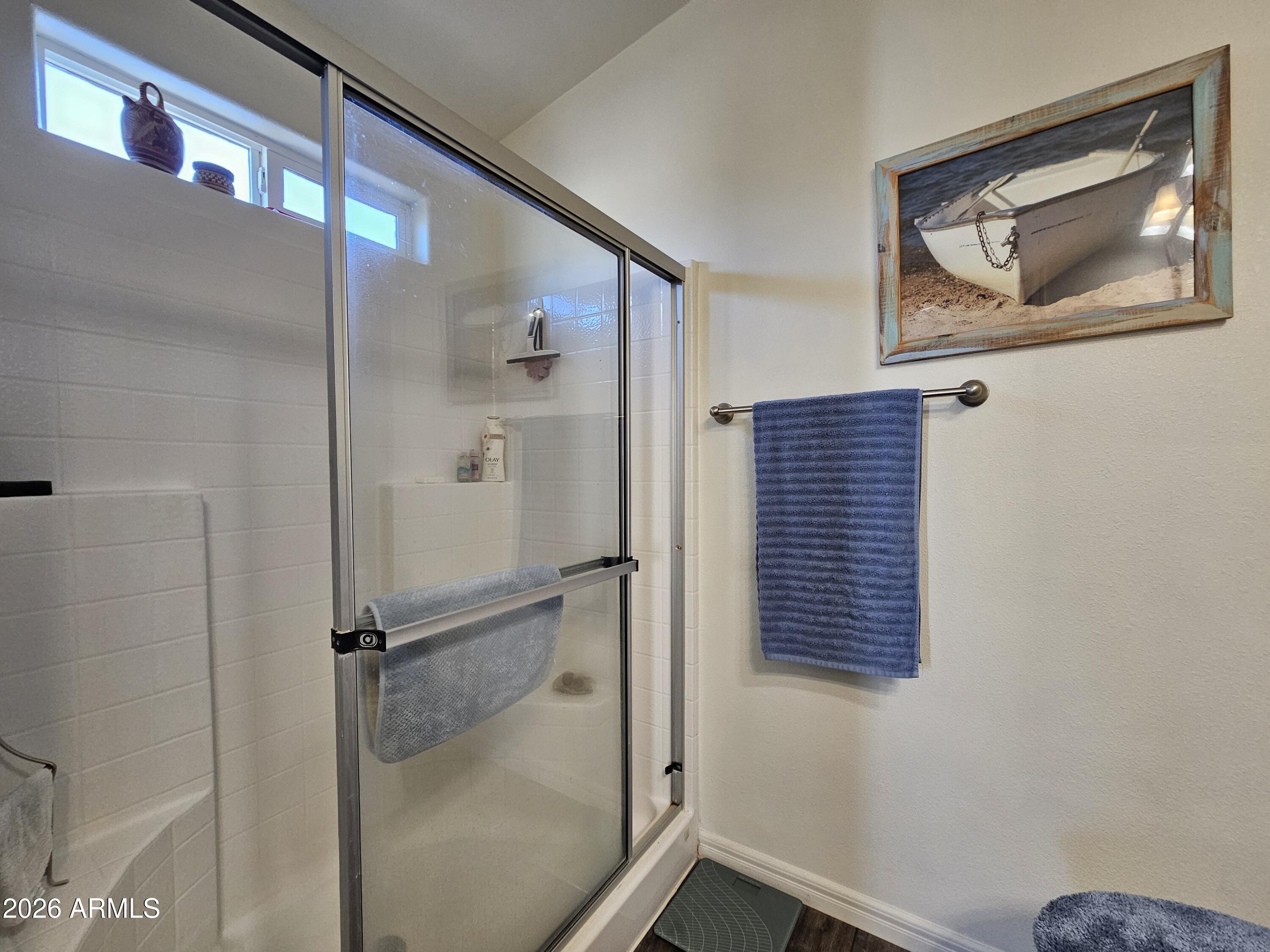 650 North Hawes Road, Unit 3202 Mesa, AZ 85207 - Photo 19 of 35 a bathroom with a shower and a window