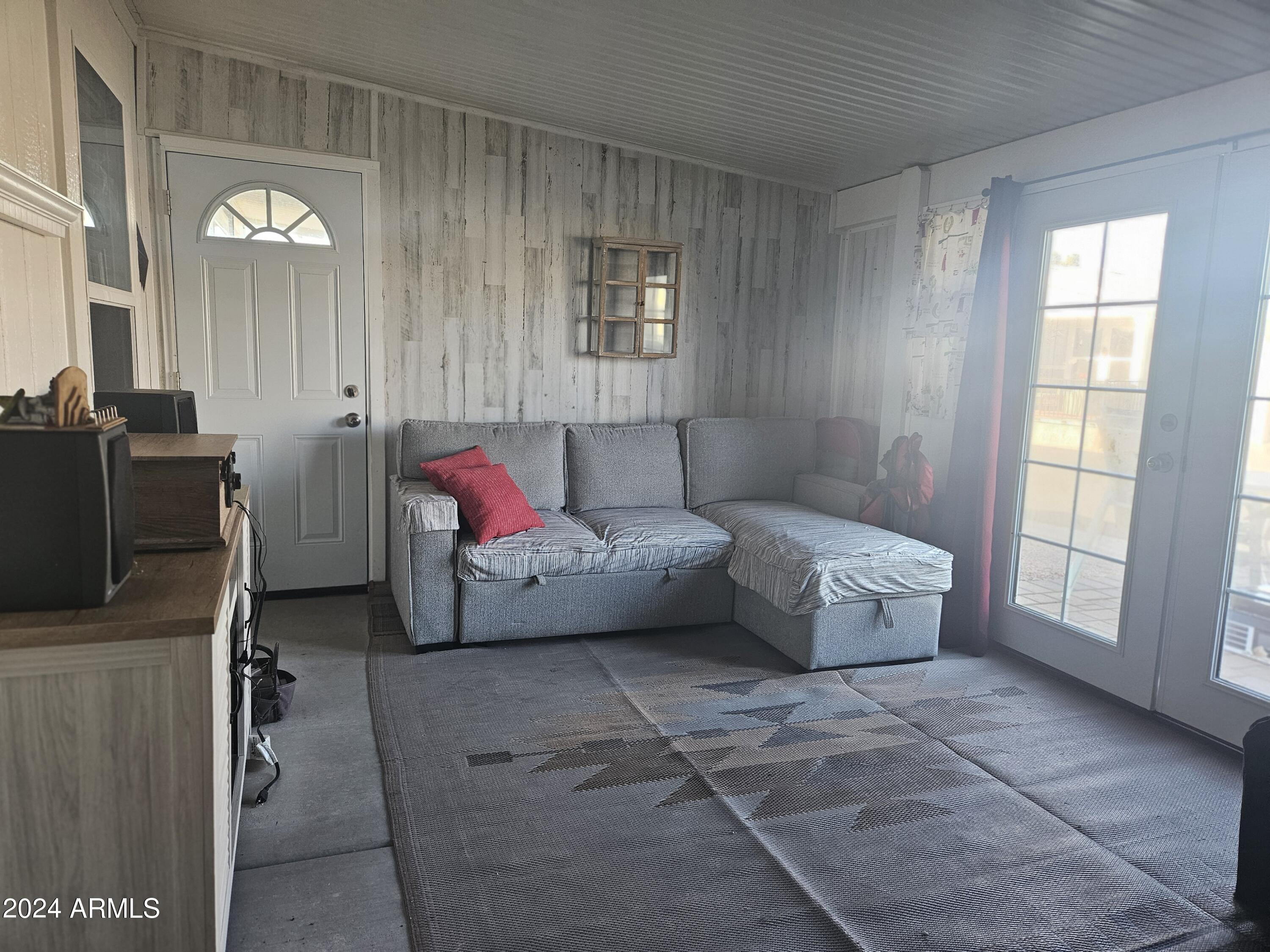 650 North Hawes Road, Unit 3202 Mesa, AZ 85207 - Photo 23 of 35 a living room with furniture and a window