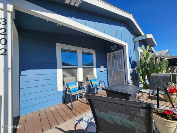 a view of backyard with outdoor seating and wooden floor