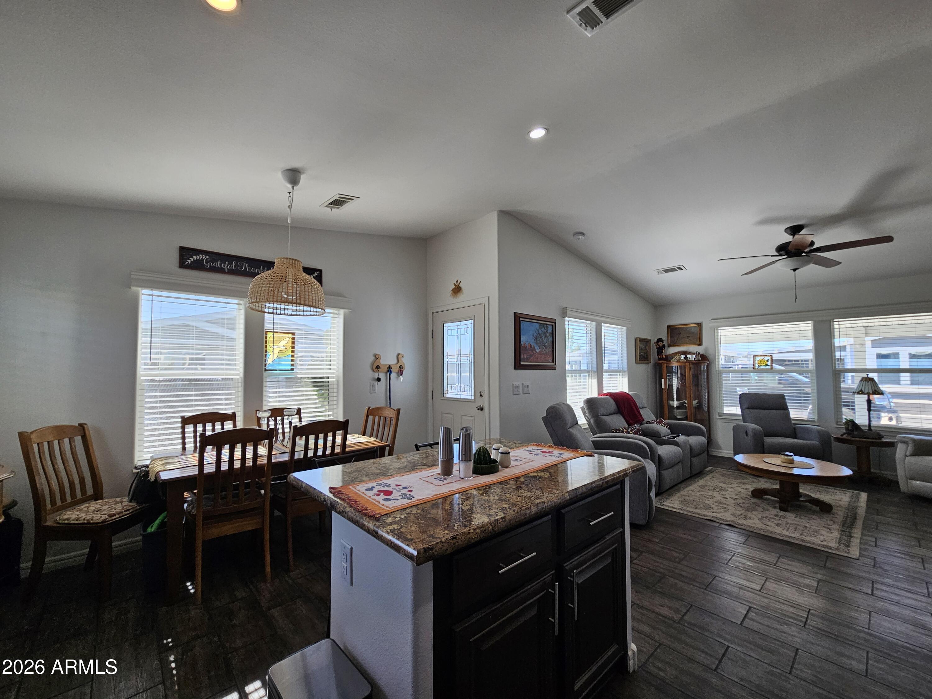 650 North Hawes Road, Unit 3202 Mesa, AZ 85207 - Photo 9 of 35 a living room with furniture a rug and a chandelier